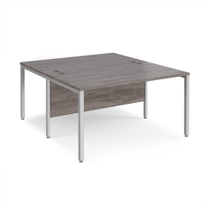 Office Monster | Maestro 25 Maestro 25 back to back straight desks 1400mm x 1600mm - silver bench leg frame, grey oak top Maestro 25 Maestro 25 back to back straight desks 1400mm x 1600mm - silver bench leg frame, grey oak top
