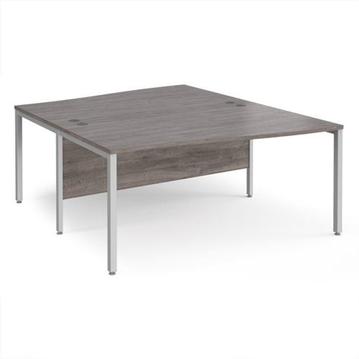 Office Monster | Maestro 25 Maestro 25 back to back wave desks 1600mm deep - silver bench leg frame, grey oak top Maestro 25 Maestro 25 back to back wave desks 1600mm deep - silver bench leg frame, grey oak top