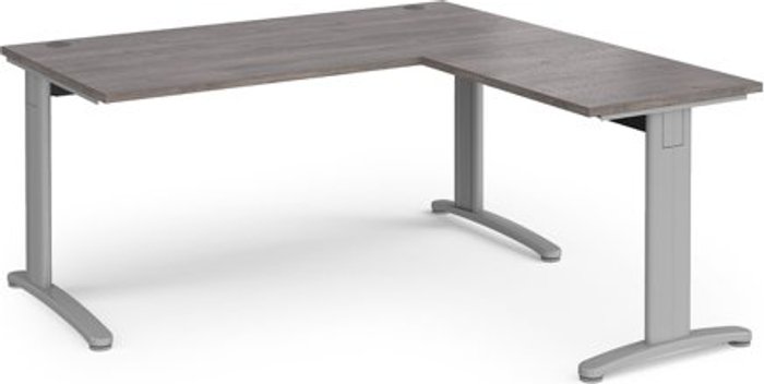 Office Monster | TR10 TR10 desk 1600mm x 800mm with 800mm return desk - silver frame, grey oak top TR10 TR10 desk 1600mm x 800mm with 800mm return desk - silver frame, grey oak top