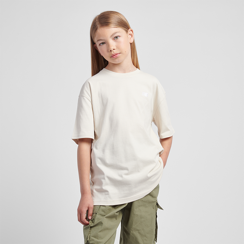 Levně Dětské tričko New Balance LAKG0001LIN – béžové
